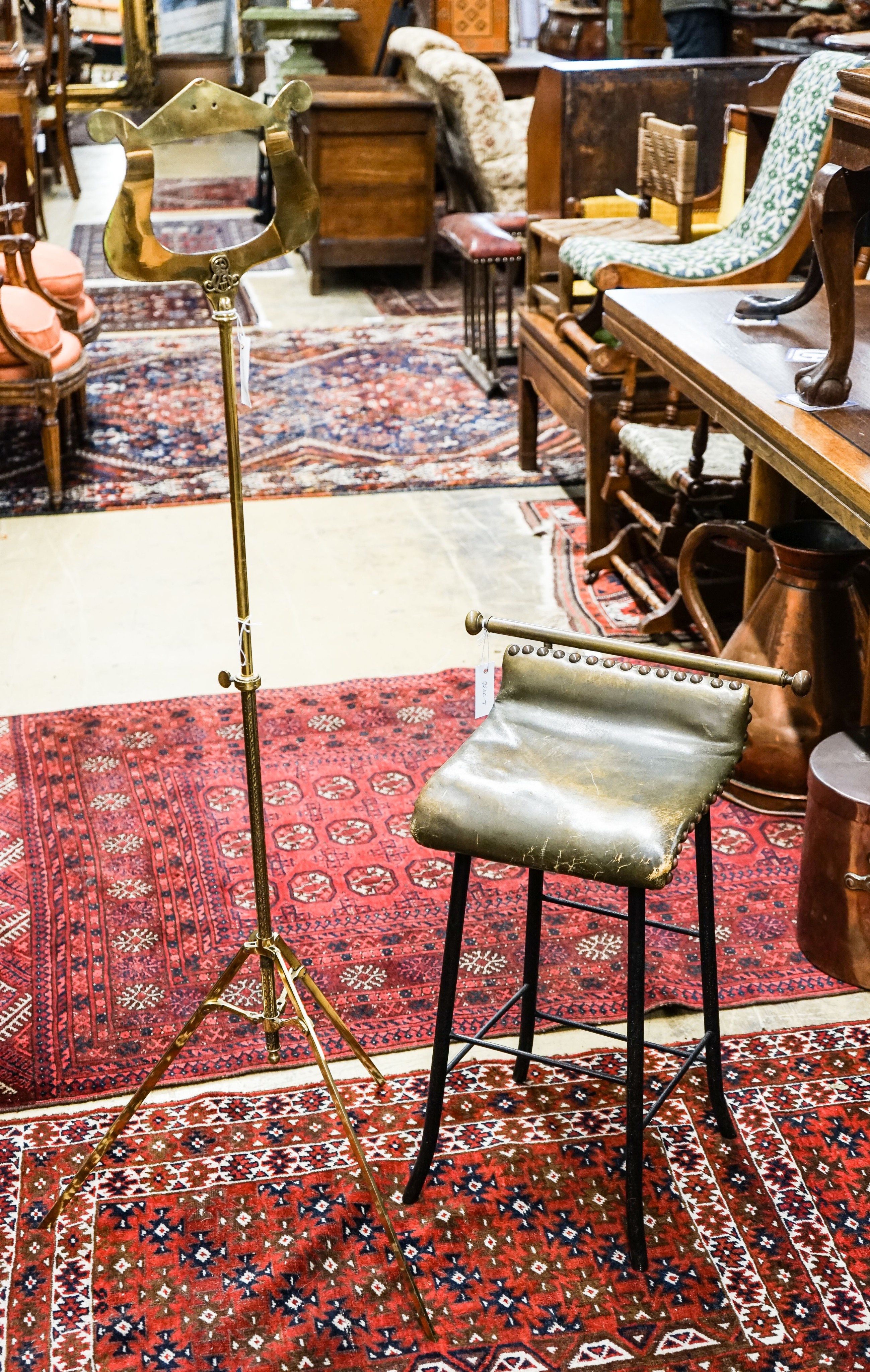 An Edwardian brass music stand and stool